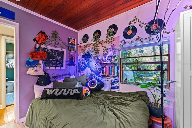 bedroom with multiple windows, wood ceiling, crown molding, and wood finished floors