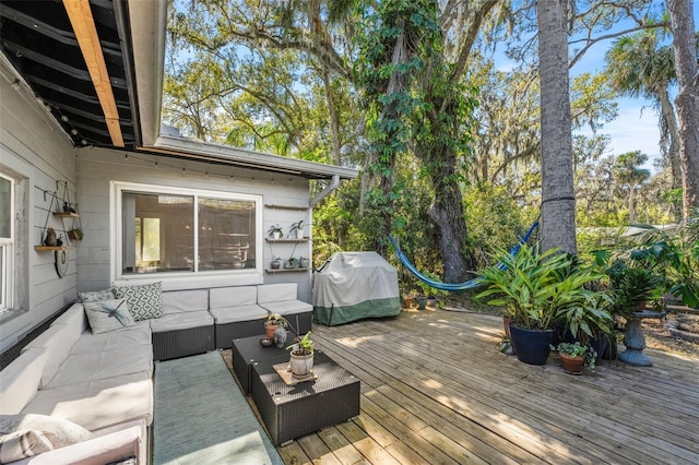 wooden terrace featuring a grill and an outdoor hangout area