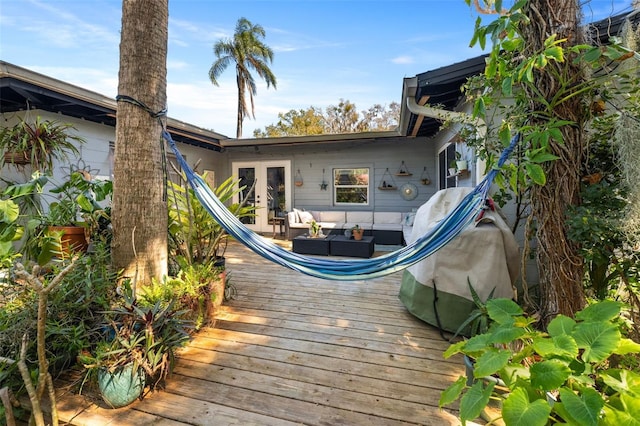 wooden terrace featuring french doors and outdoor lounge area