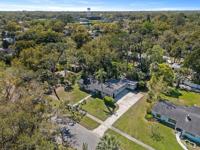 drone / aerial view with a wooded view