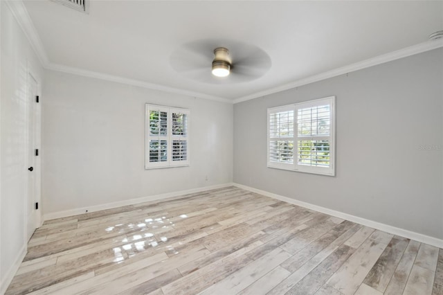 spare room featuring crown molding, plenty of natural light, light wood-style flooring, and a ceiling fan