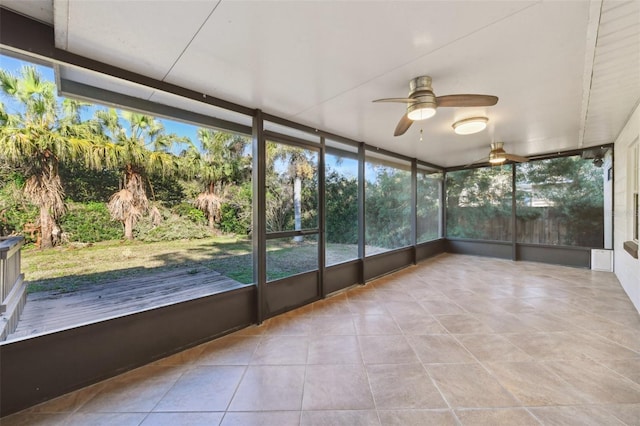 unfurnished sunroom with ceiling fan