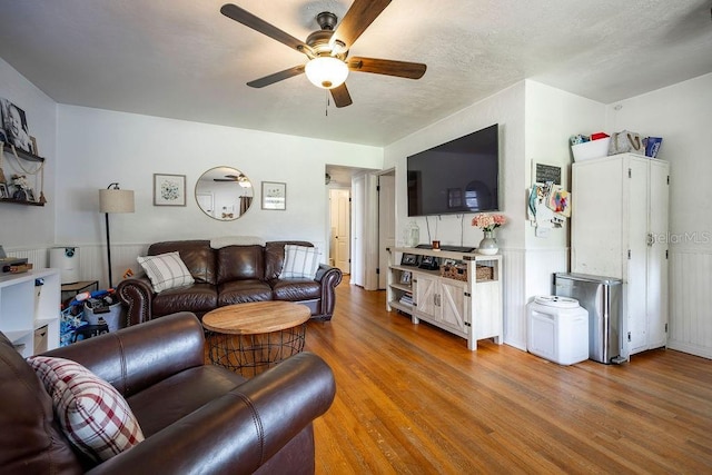 living room featuring a ceiling fan and wood finished floors