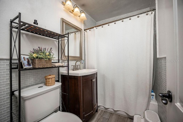 full bath with shower / bath combination with curtain, vanity, toilet, and wood finished floors