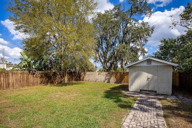 view of yard featuring a fenced backyard, a shed, and an outdoor structure