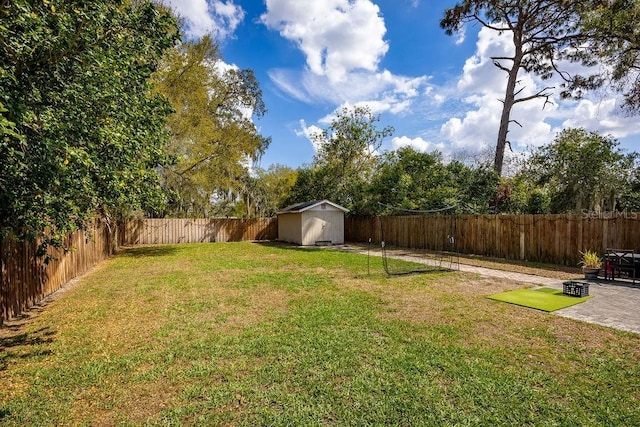 view of yard featuring a storage shed, a patio area, an outdoor structure, and a fenced backyard