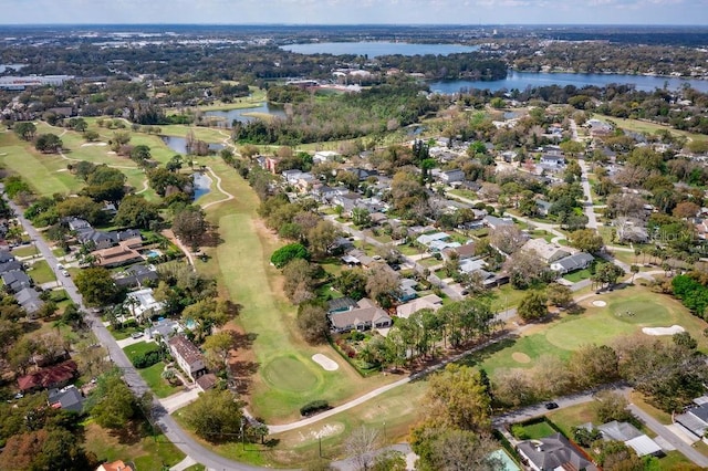 birds eye view of property with golf course view, a water view, and a residential view