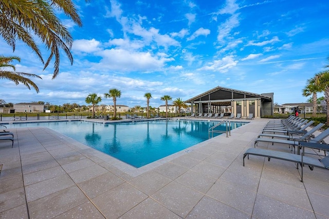 community pool featuring a patio area and fence