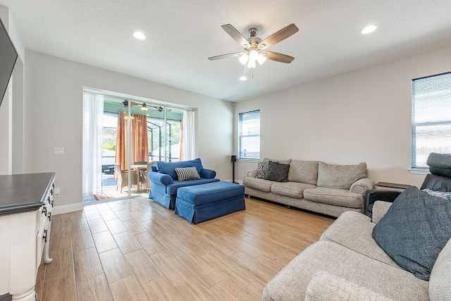 living area with light wood-style floors, recessed lighting, and ceiling fan