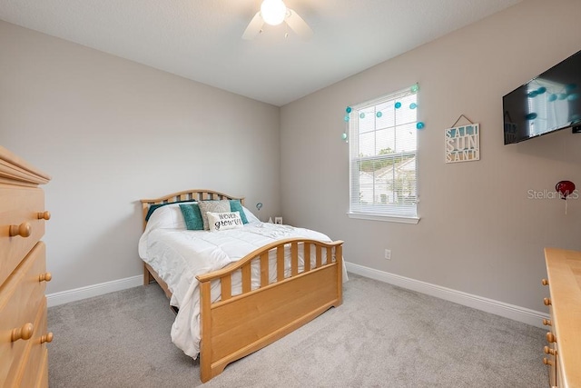 bedroom with carpet, baseboards, and a ceiling fan