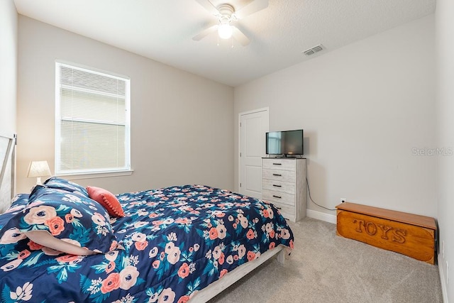 bedroom featuring baseboards, carpet floors, visible vents, and a ceiling fan