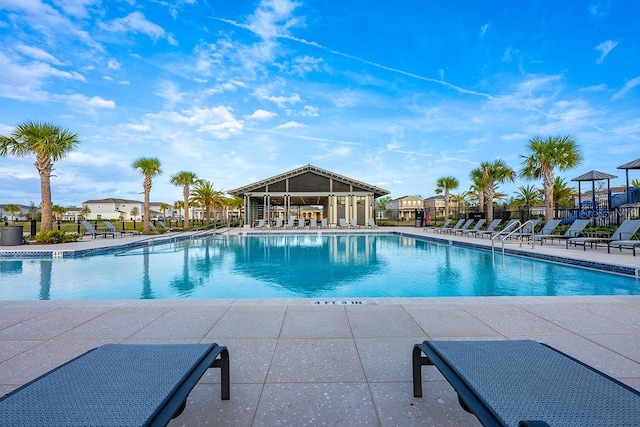 pool featuring a patio area and fence