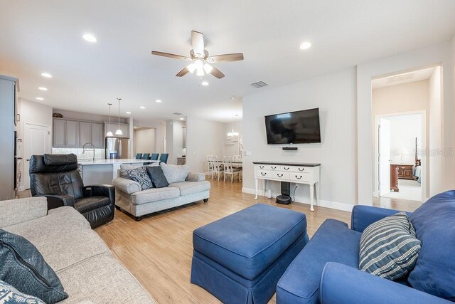 living area featuring light wood finished floors, visible vents, and recessed lighting