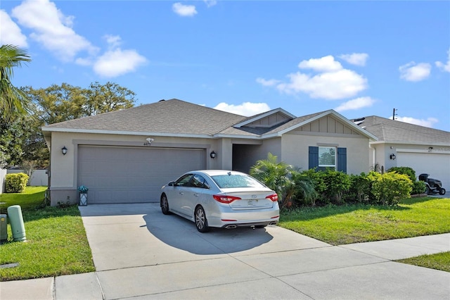 single story home featuring board and batten siding, a front yard, concrete driveway, and an attached garage