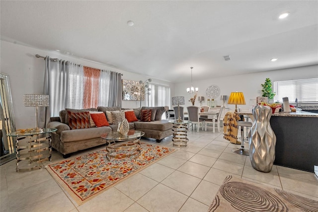 living area featuring light tile patterned floors, recessed lighting, visible vents, and an inviting chandelier