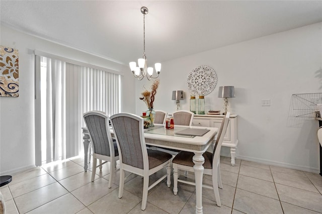 dining space featuring light tile patterned floors, baseboards, and an inviting chandelier