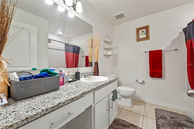 full bathroom with toilet, vanity, baseboards, visible vents, and tile patterned floors