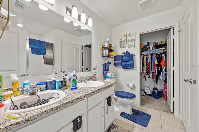 full bath with a stall shower, visible vents, a sink, and tile patterned floors