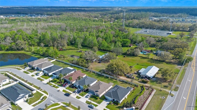 birds eye view of property featuring a water view, a residential view, and a view of trees