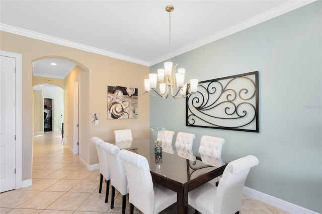 dining area featuring light tile patterned floors, baseboards, arched walkways, crown molding, and a chandelier