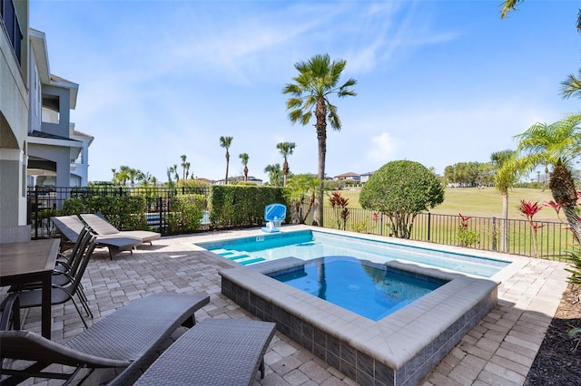 view of swimming pool with an in ground hot tub, fence private yard, and a patio area