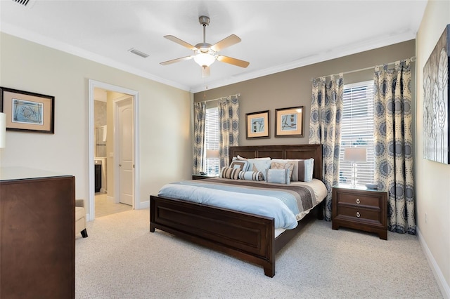 carpeted bedroom featuring visible vents, a ceiling fan, ensuite bathroom, crown molding, and baseboards