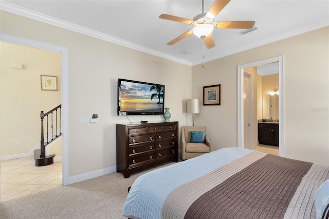 bedroom with baseboards, visible vents, light carpet, crown molding, and connected bathroom