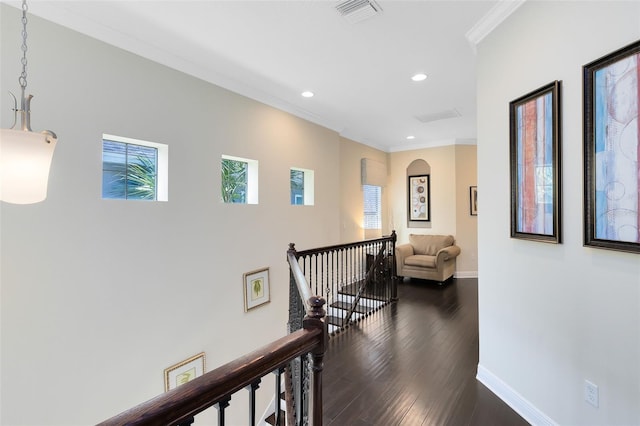 hall with baseboards, an upstairs landing, visible vents, and ornamental molding