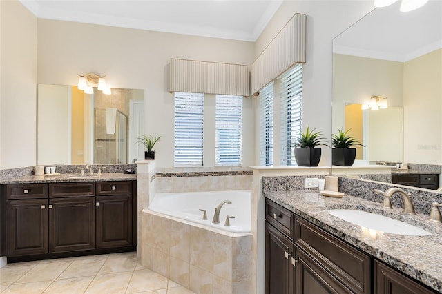 full bathroom featuring a shower stall, ornamental molding, a bath, and a sink