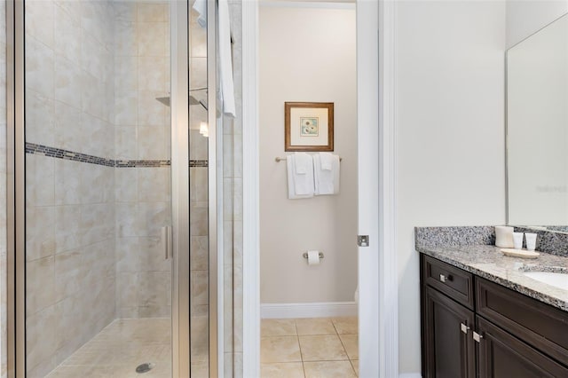 bathroom featuring tile patterned flooring, toilet, a stall shower, and vanity