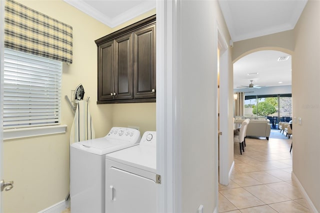 washroom with washing machine and clothes dryer, light tile patterned flooring, cabinet space, ceiling fan, and crown molding