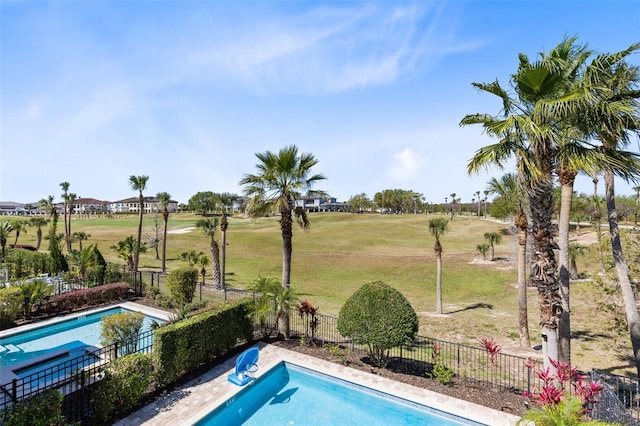 view of pool with fence, a fenced in pool, and a lawn