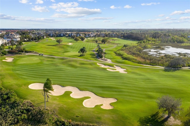 exterior space with golf course view and a water view