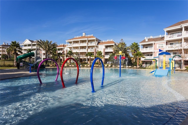 view of pool with playground community