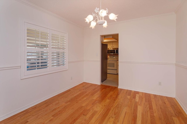 unfurnished dining area featuring a chandelier, light wood finished floors, baseboards, and crown molding