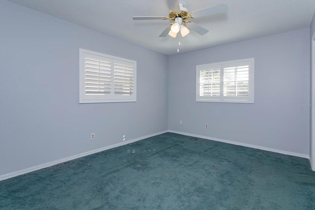 spare room featuring carpet floors, ceiling fan, and baseboards