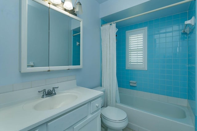 bathroom featuring toilet, shower / bath combo, and vanity