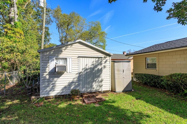 view of shed featuring fence