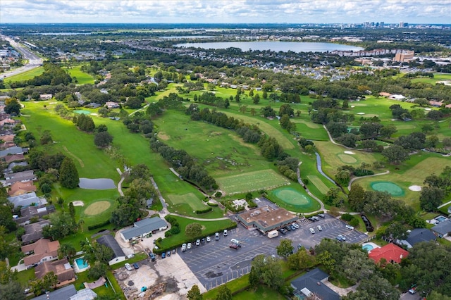 birds eye view of property with a water view and golf course view