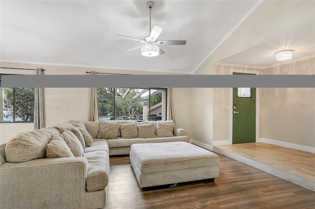 living area featuring wood finished floors, a ceiling fan, baseboards, vaulted ceiling, and ornamental molding