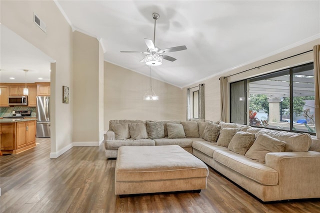 living room with visible vents, ornamental molding, vaulted ceiling, wood finished floors, and baseboards