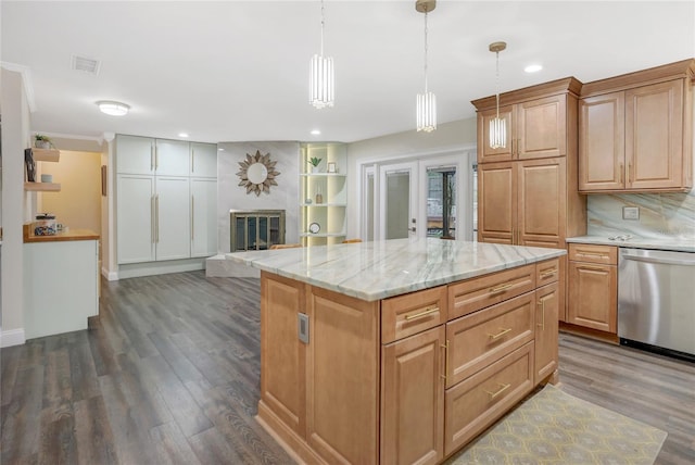 kitchen with visible vents, a fireplace with raised hearth, decorative backsplash, dishwasher, and dark wood-type flooring