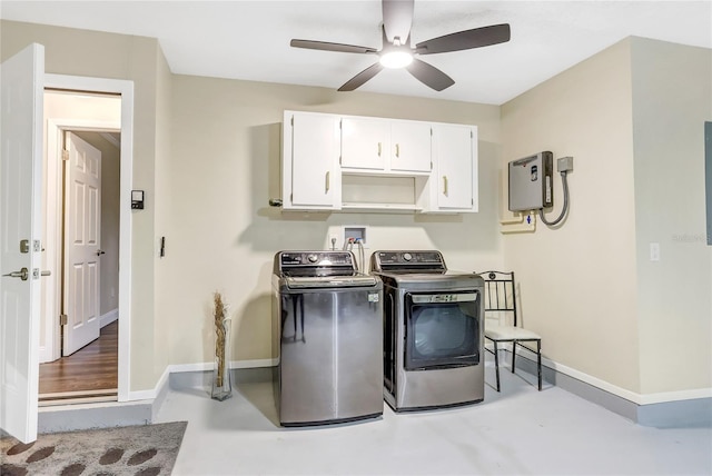 washroom featuring baseboards, ceiling fan, cabinet space, and washer and dryer