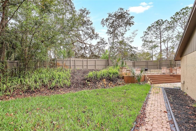 view of yard with a deck and a fenced backyard