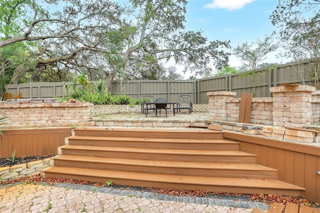 deck featuring a patio area and fence