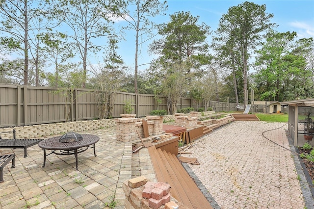 view of patio with a fire pit and a fenced backyard