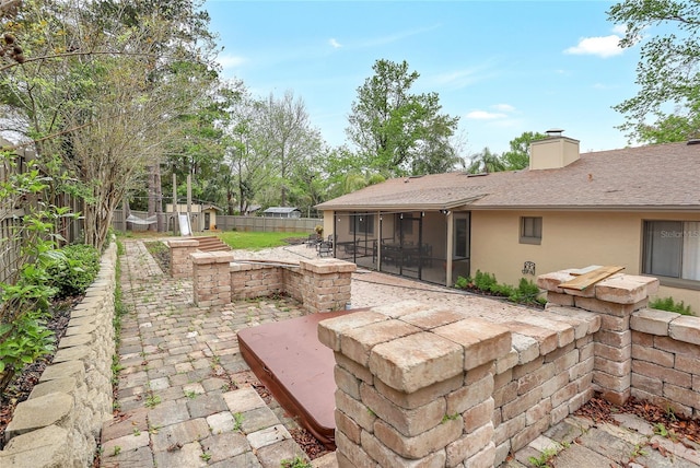 view of patio featuring a sunroom and a fenced backyard