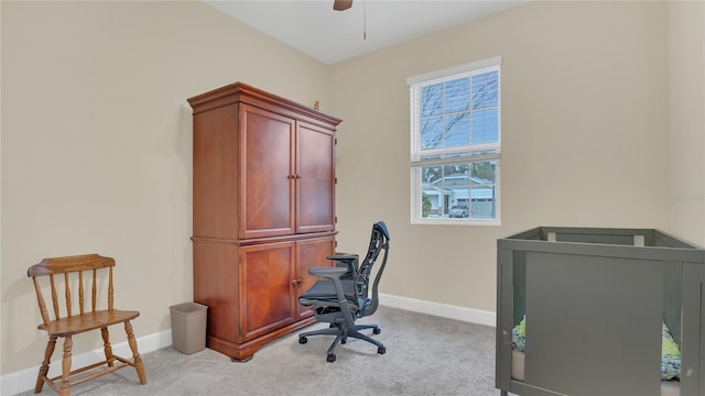 office featuring light carpet, ceiling fan, and baseboards