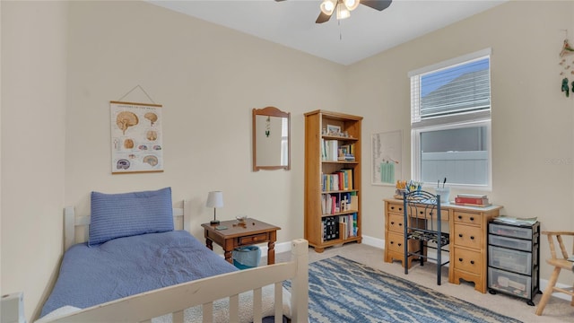 bedroom with a ceiling fan, carpet, and baseboards