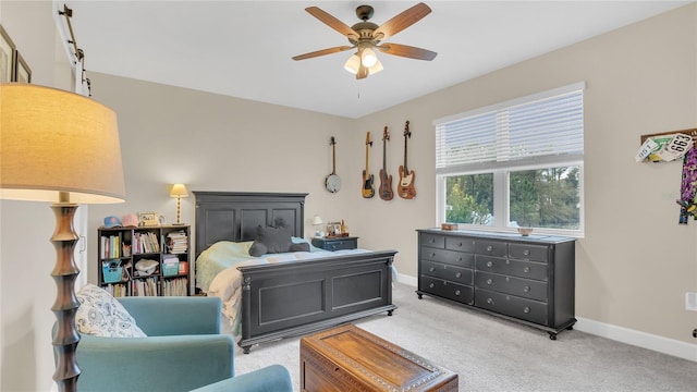 bedroom featuring baseboards, light carpet, and a ceiling fan